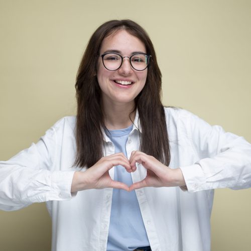 front-view-smiley-woman-making-heart-shape